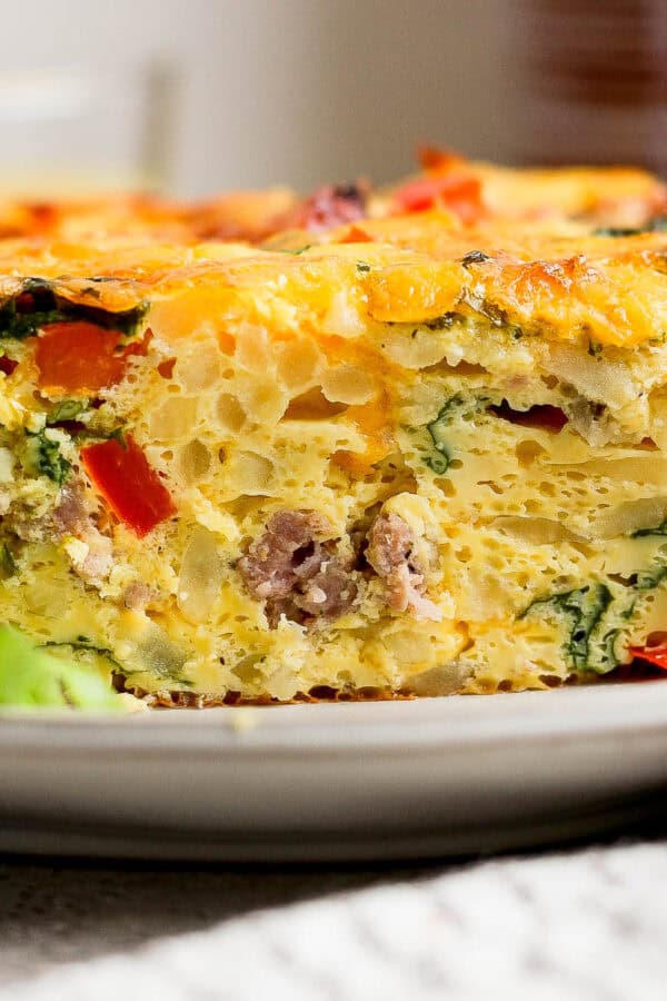 A slice a hash brown egg bake on a plate.