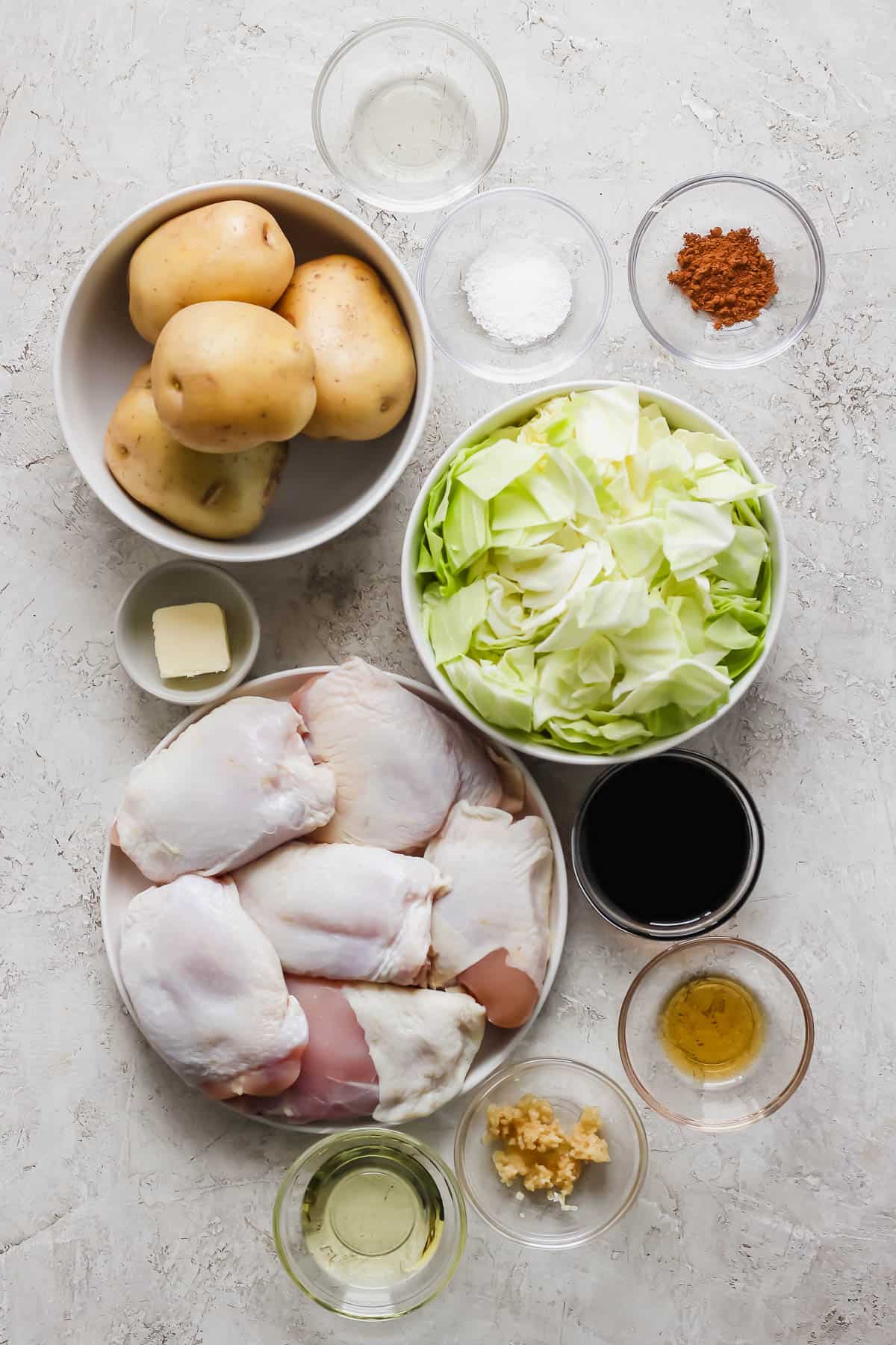 Ingredients for sheet pan chicken thighs in separate bowls.