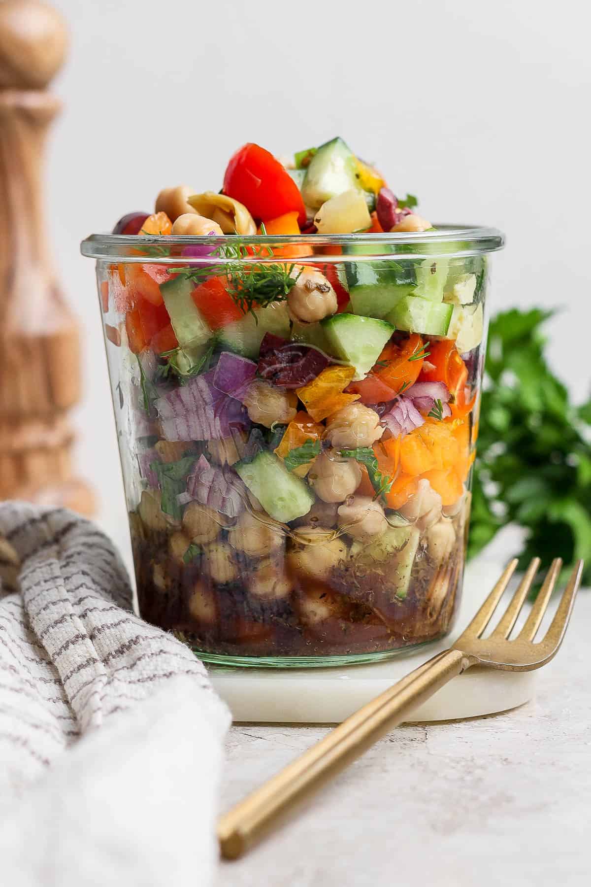 A large mason jar filled with salad.