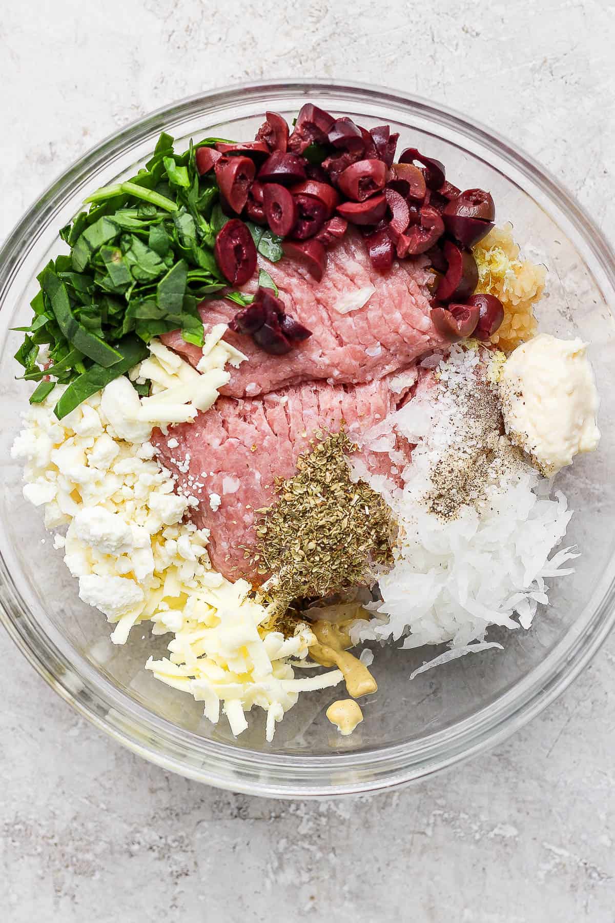 Greek turkey burgers with tzatziki sauce ingredients in a bowl.