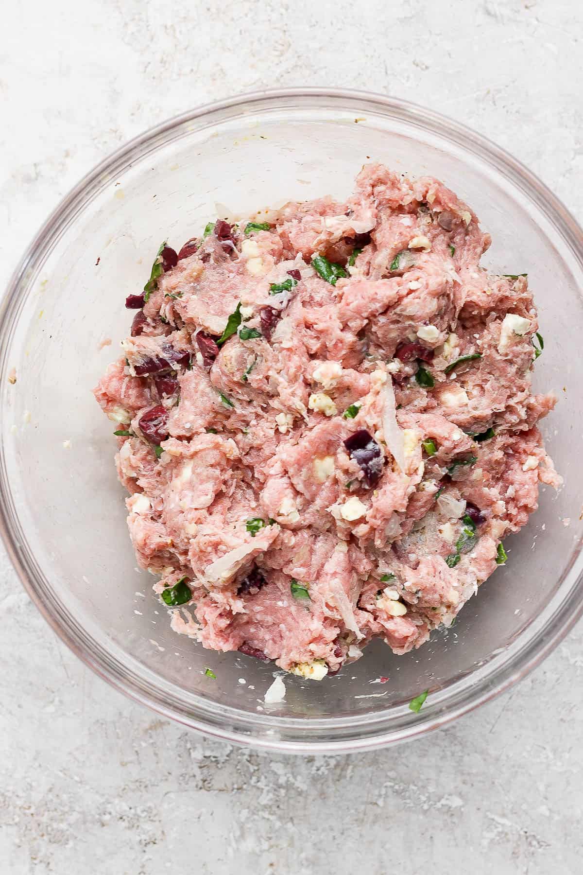 Greek turkey burger with tzatziki sauce ingredients mixed in a bowl.