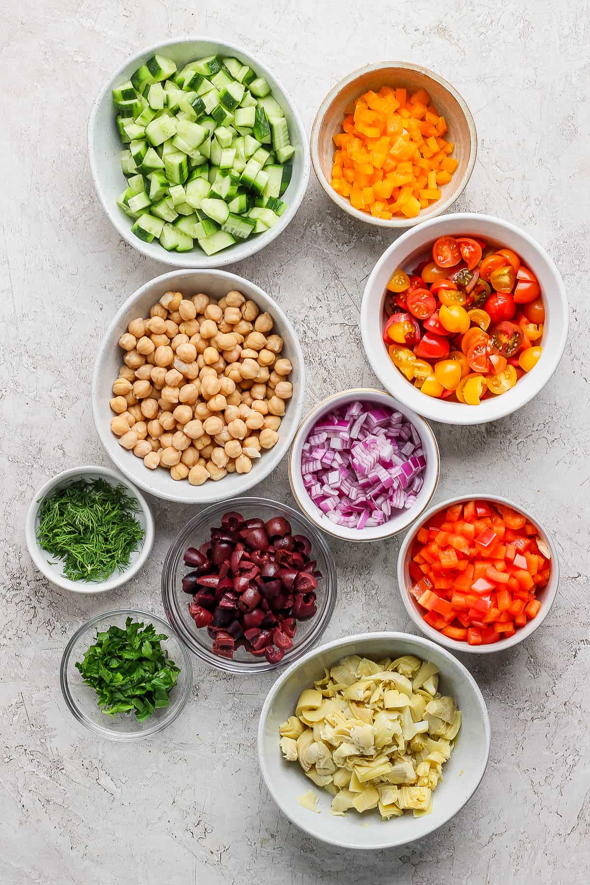 Salad ingredients in separate bowls.