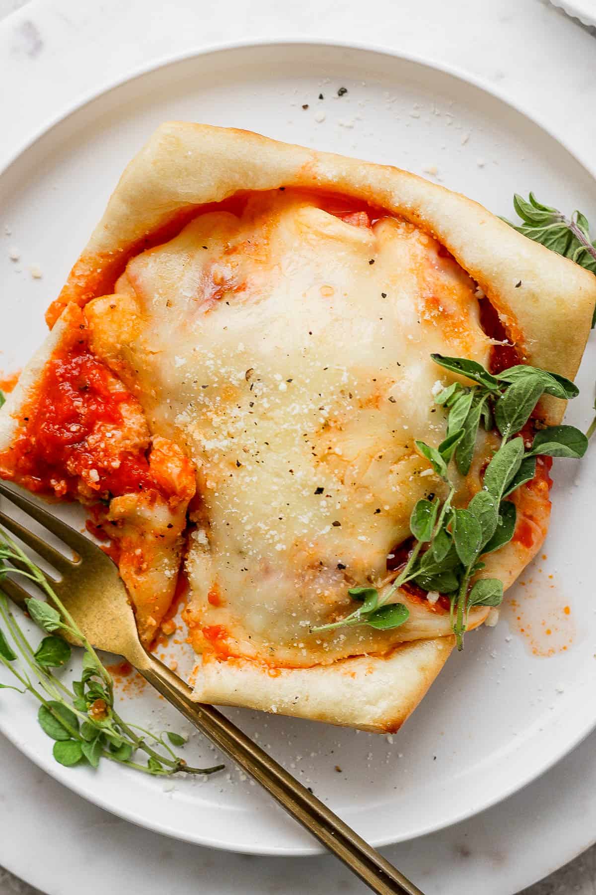 Pizza pot pie on a plate with a fork.