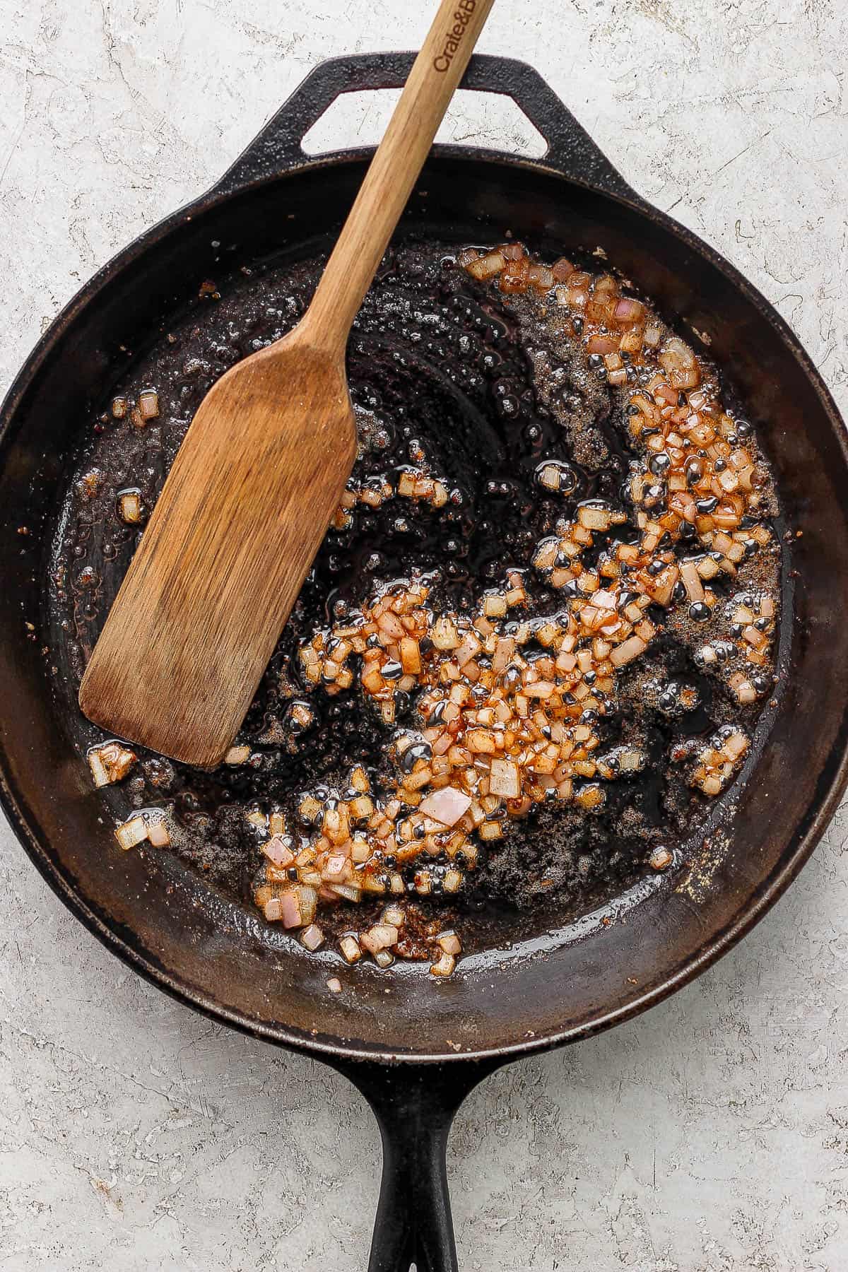 Shallots cooking in a skillet.