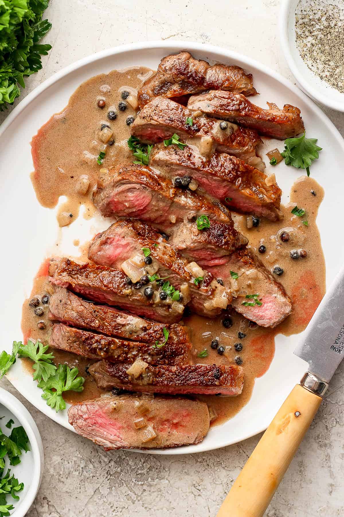 Steak au Poivre on a white plate.