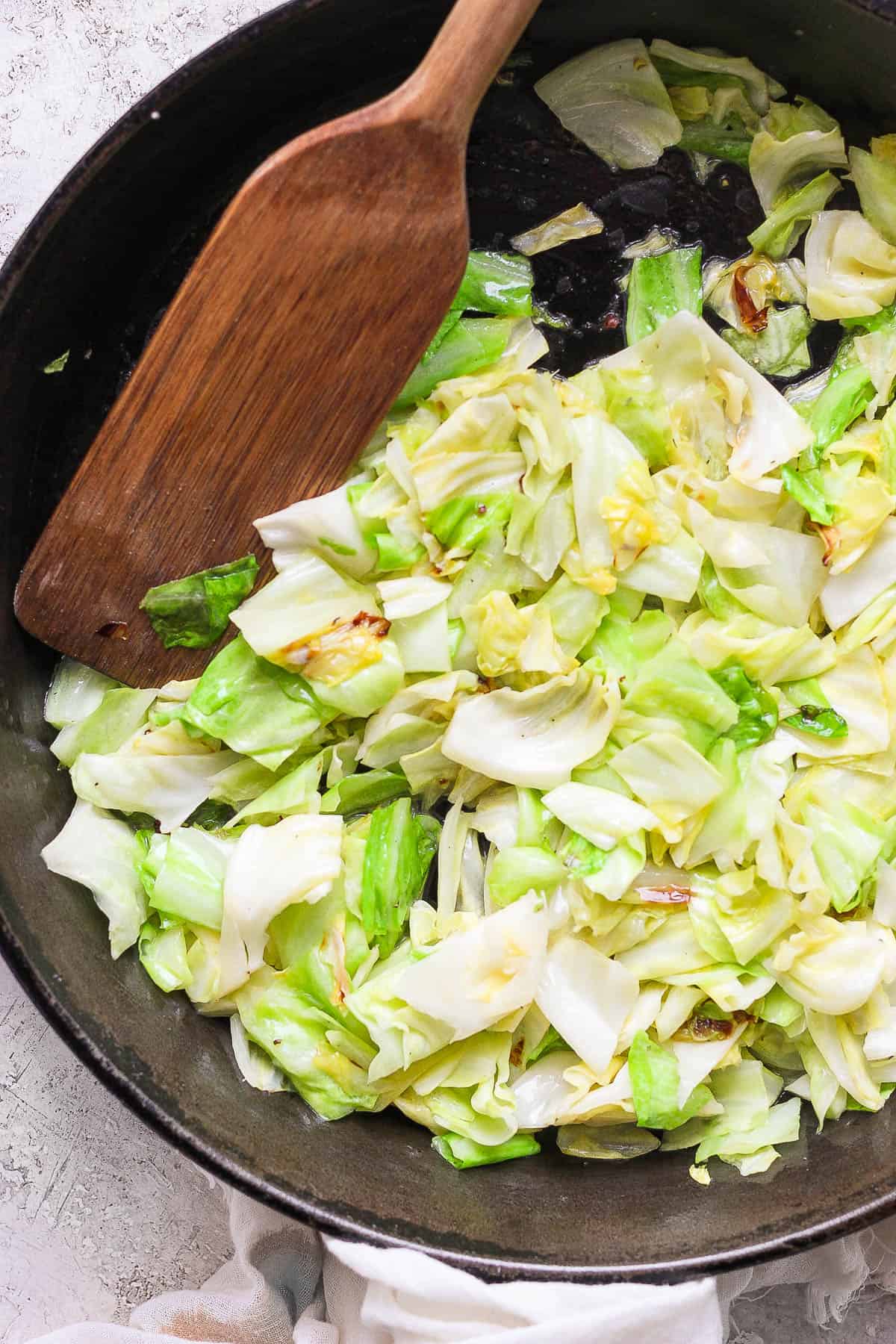 Sautéed cabbage in a cast iron skillet.