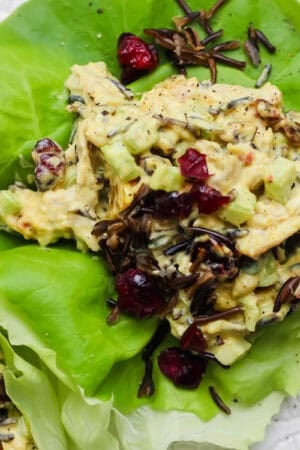 Curried chicken salad in a lettuce wrap with wild rice and dried cranberries.