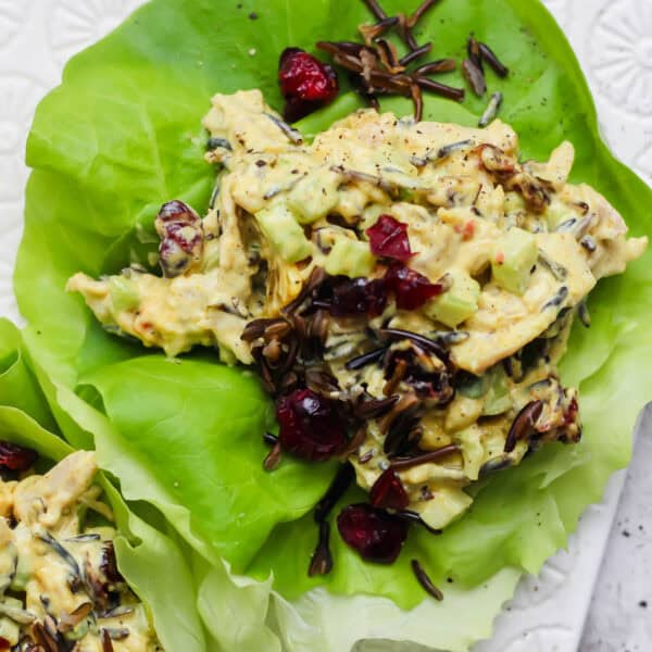 Curried chicken salad in a lettuce wrap with wild rice and dried cranberries.
