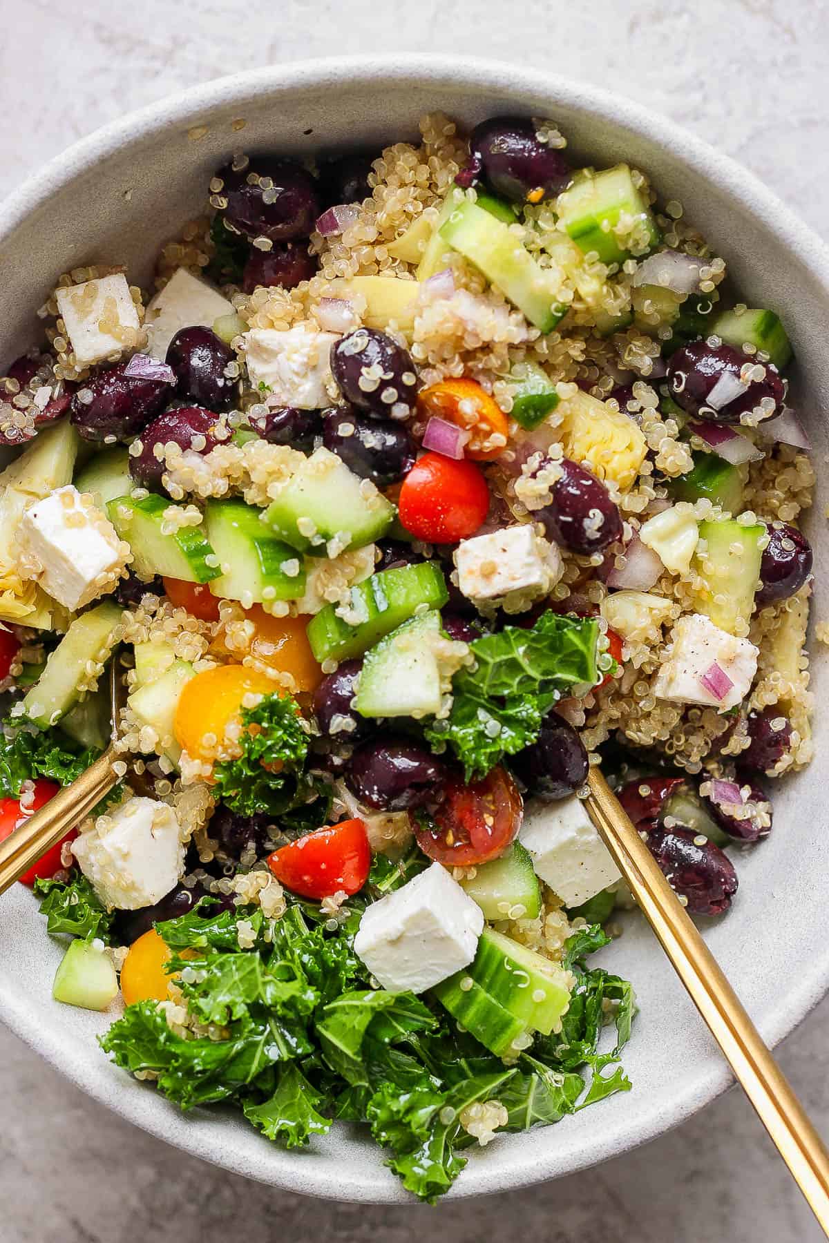 All of the salad ingredients mixed in a bowl.