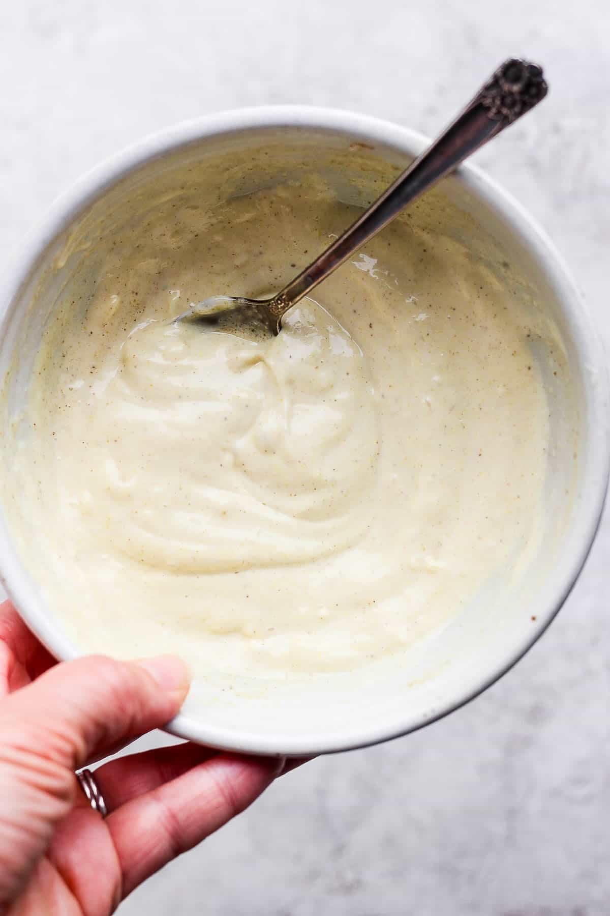 Mayo and seasonings in a bowl to make the base of dill pickle egg salad.