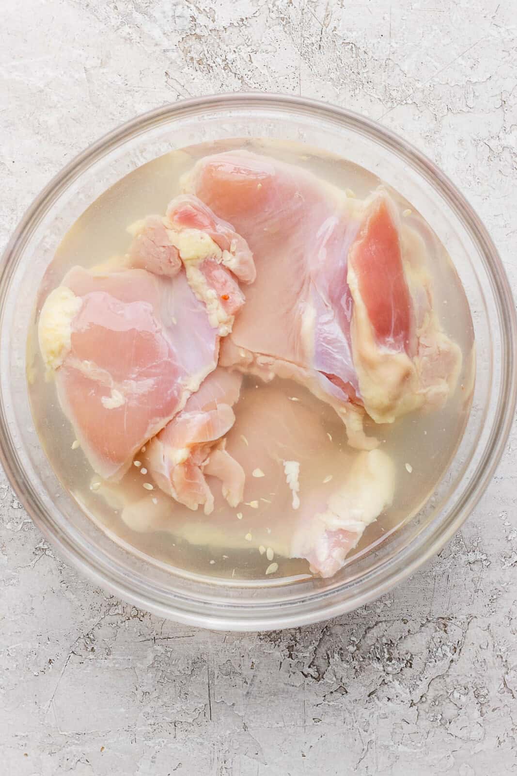 Chicken thighs marinating in pickle juice.
