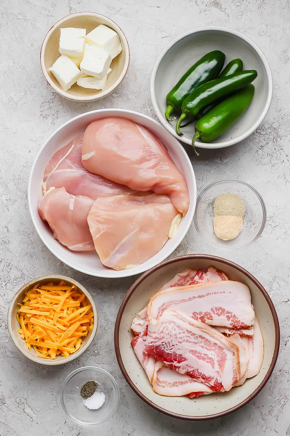 Ingredients for grilled jalapeno popper chicken in separate bowls.