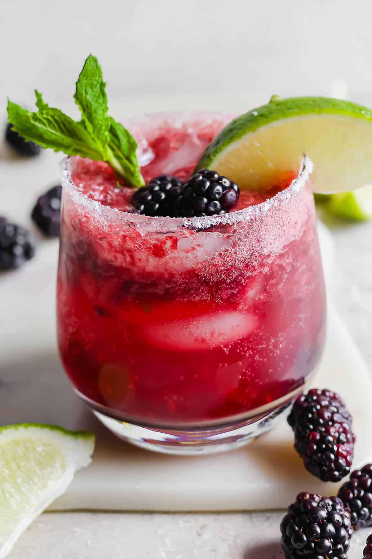 A fully garnished blackberry mojito.