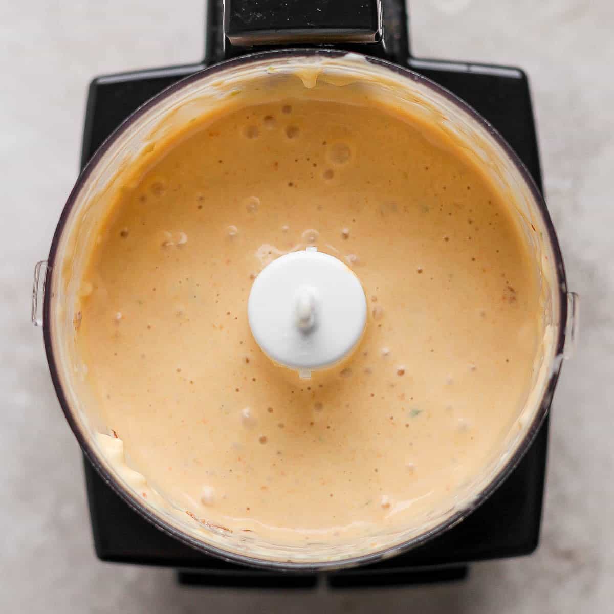 A small food processor filled with chipotle lime sauce.