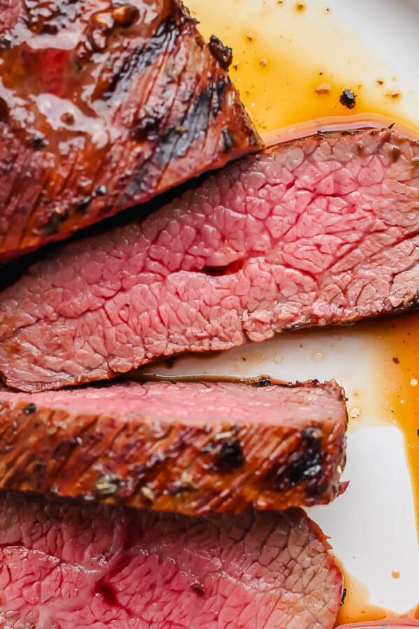 A plate filled with sliced grilled trip tip.