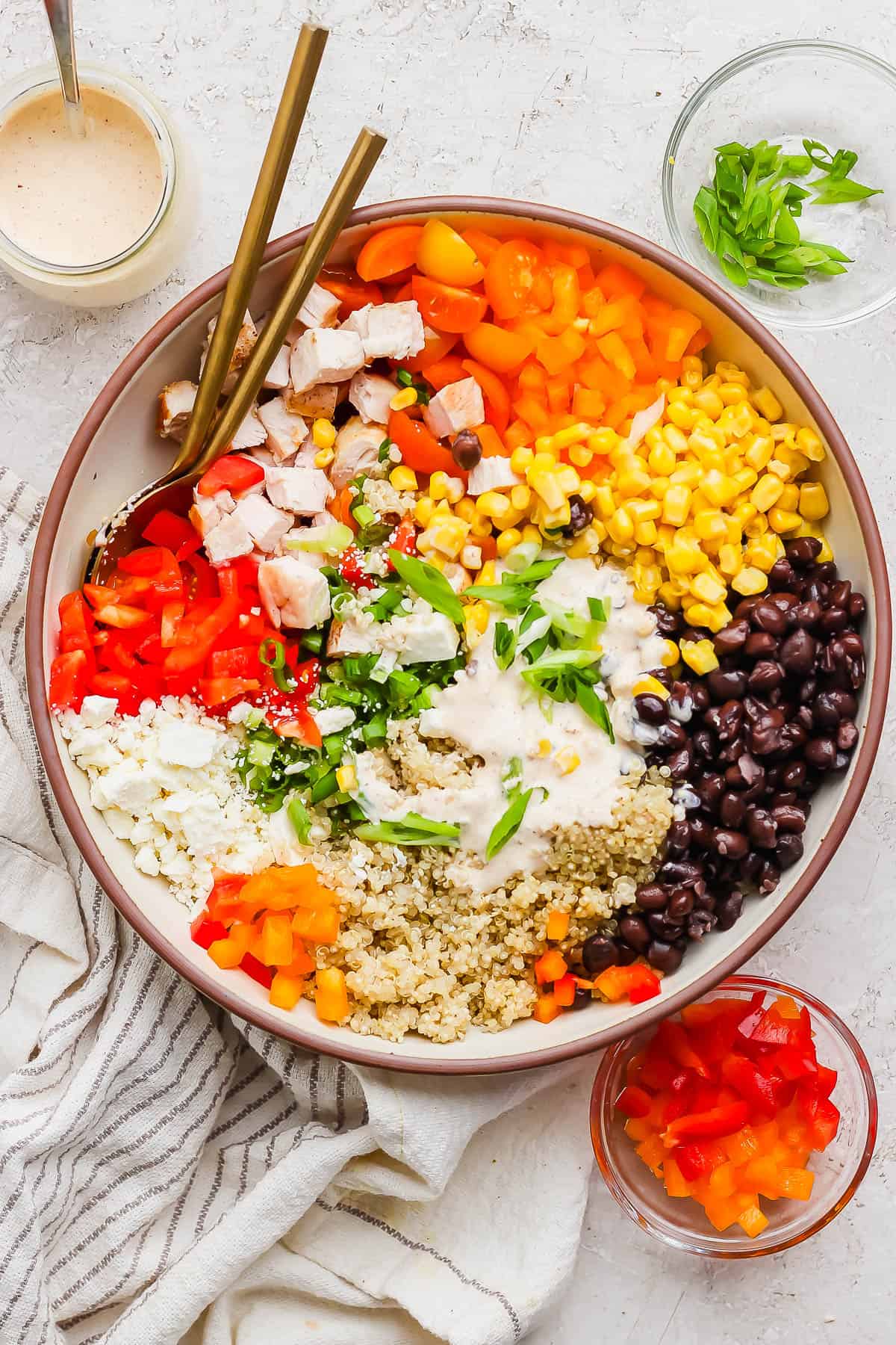 Southwest Quinoa salad in a shallow serving bowl with two spoons.