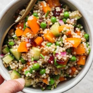 A bowl of acini de pepe salad in a bowl with a spoon sticking out.