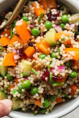 A bowl of acini de pepe salad in a bowl with a spoon sticking out.