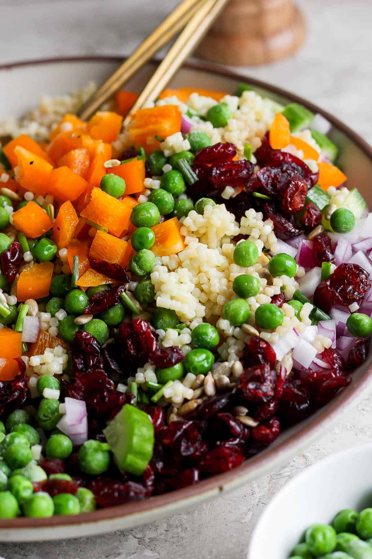 An acini di pepe salad mixed in a serving bowl.