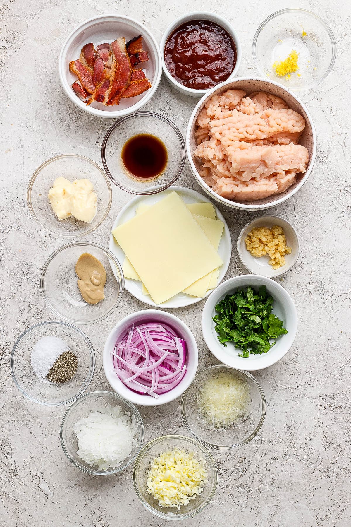 Ingredients for BBQ chicken smash burgers in separate bowls.