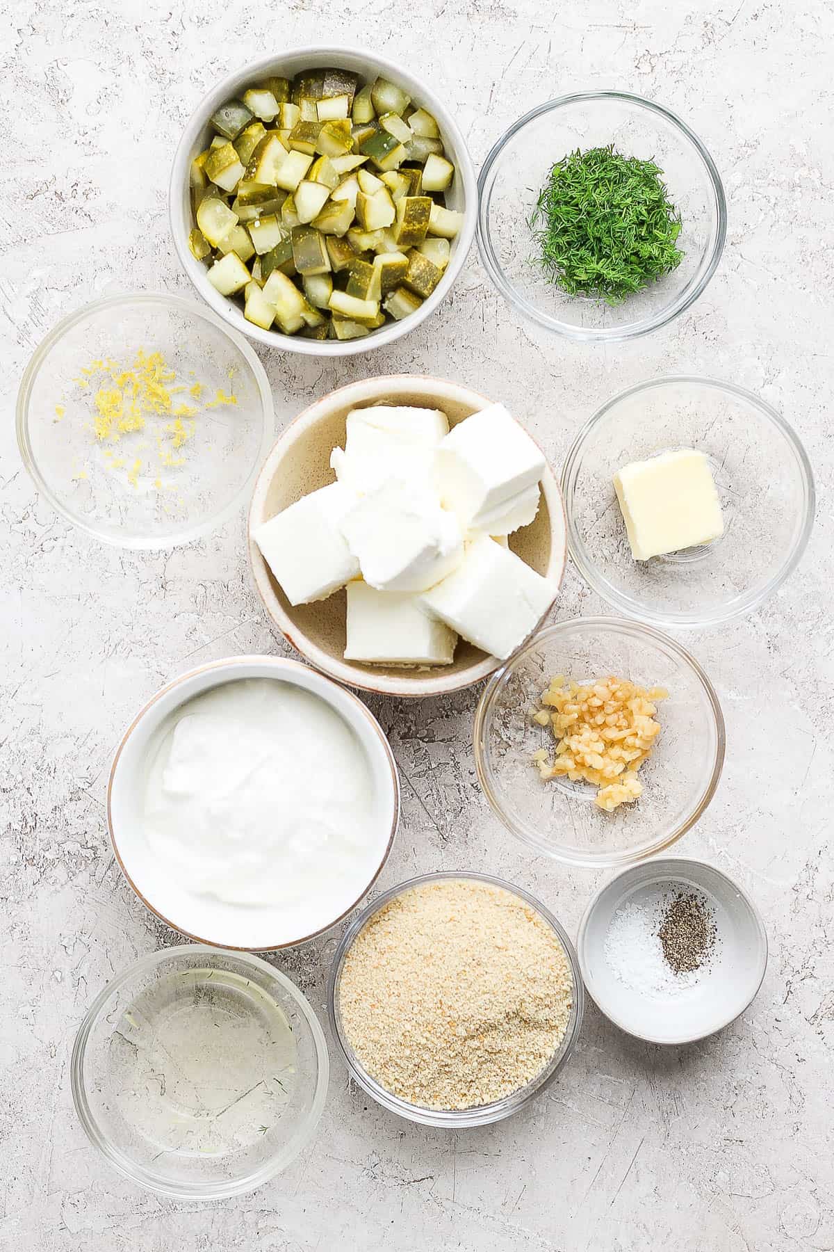 Ingredients for fried pickle dip in separate bowls.