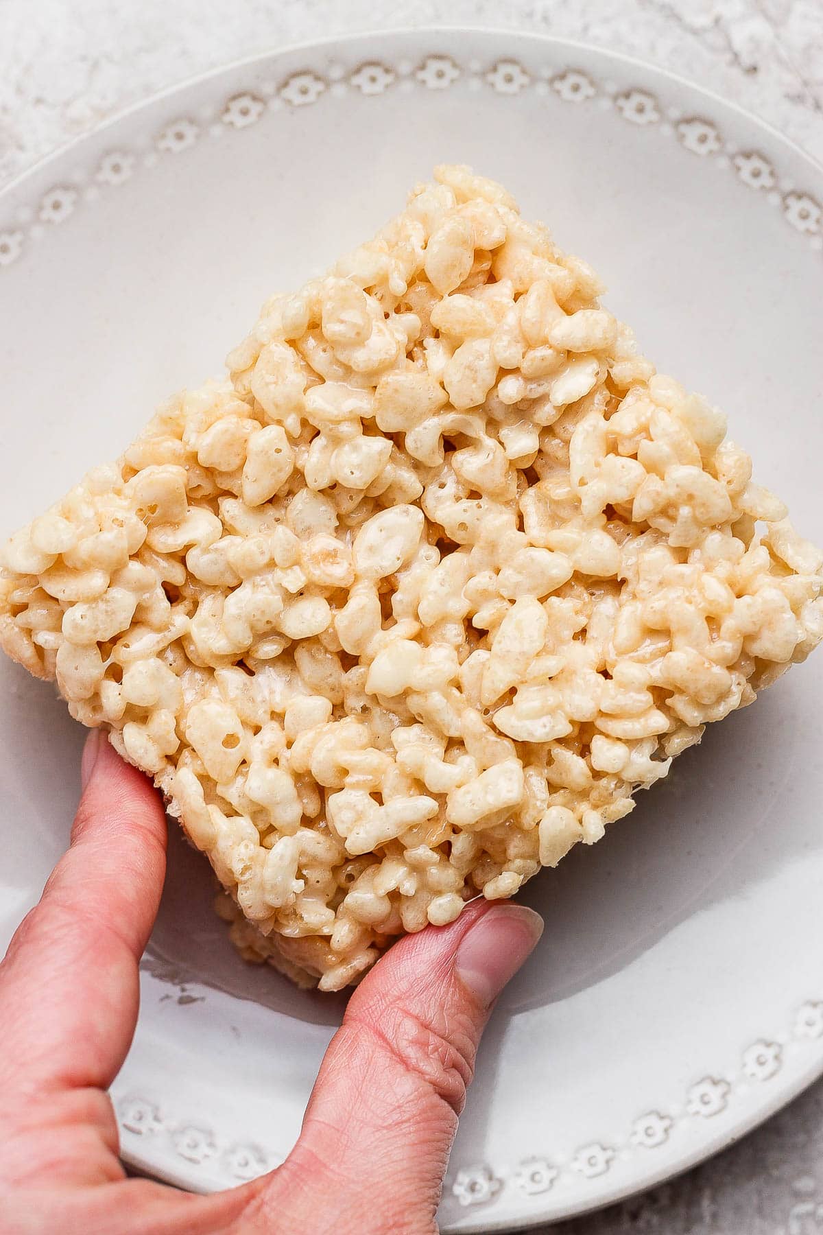 A square rice Krispie treat on a plate.