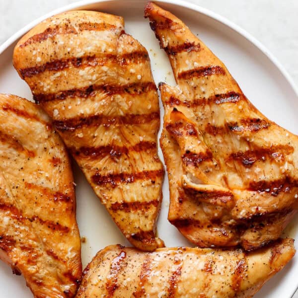 A plate of grilled chicken cutlets.