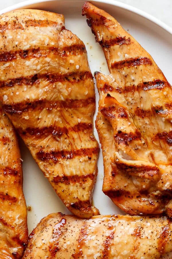 A plate of grilled chicken cutlets.