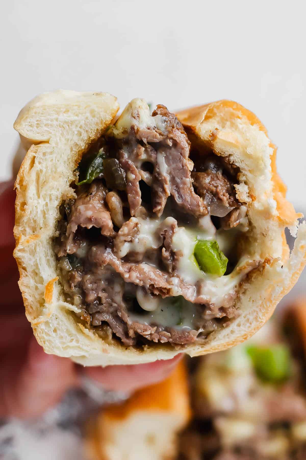 A philly cheese steak cut in half.