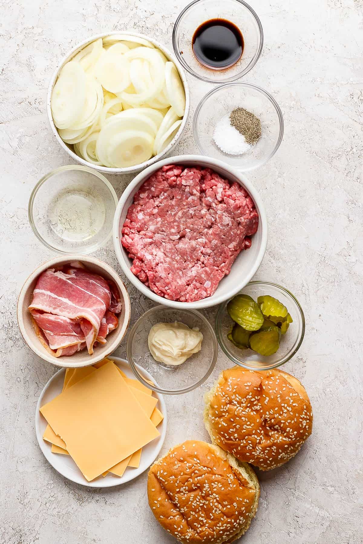 Ingredients for the burgers in separate bowls.