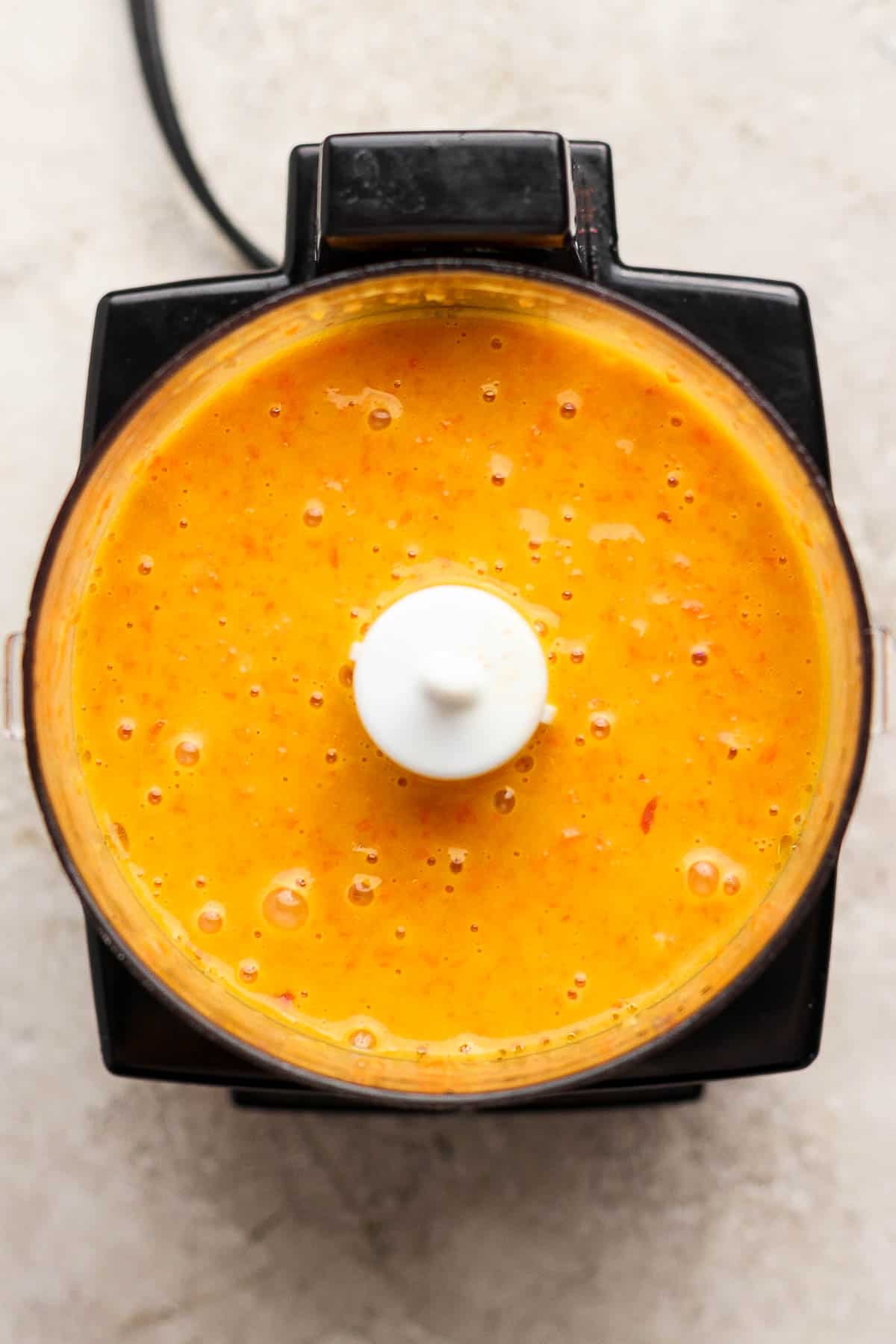 Carrot ginger dressing in a small food processor.
