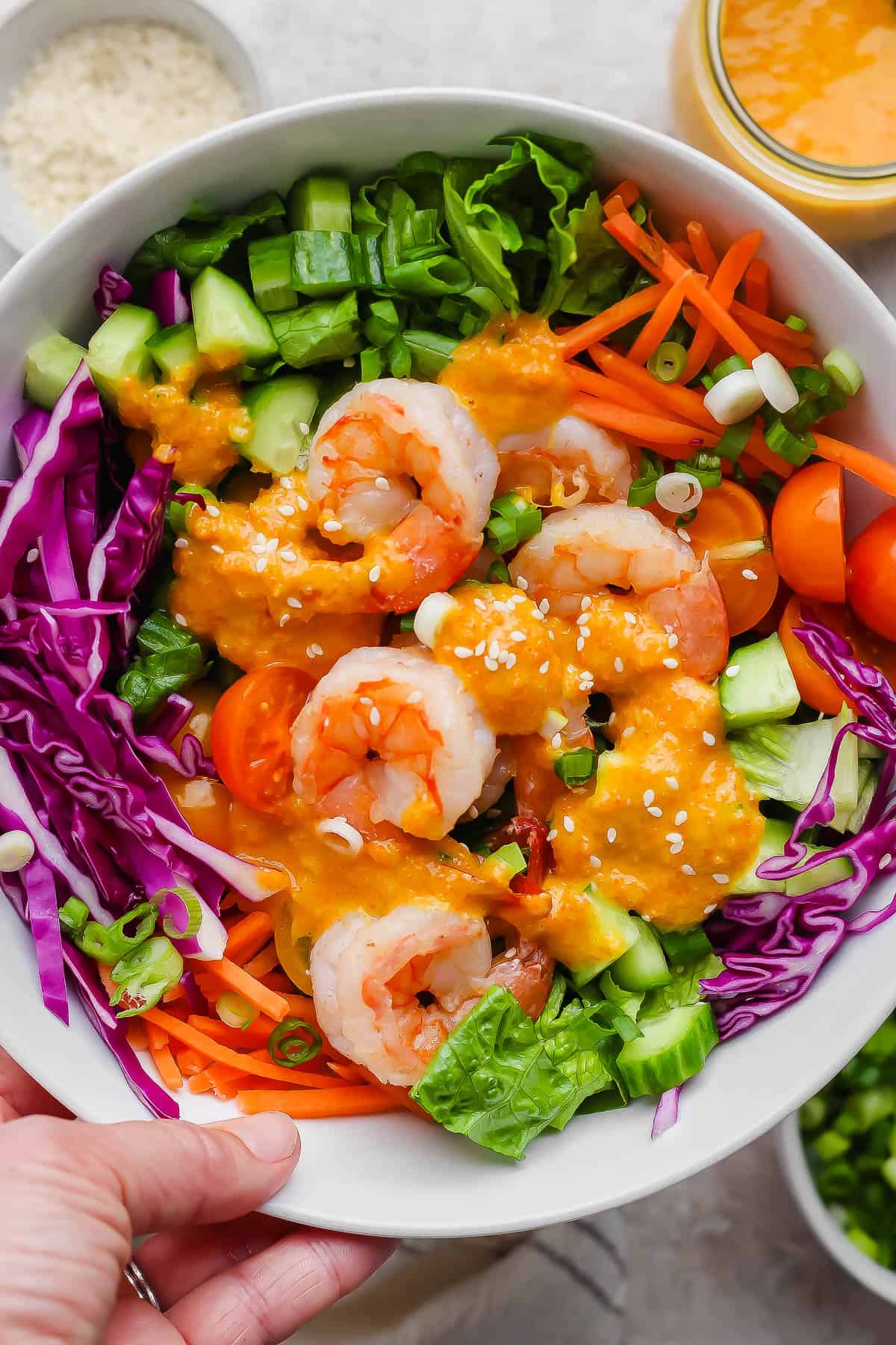 Ginger salad in a bowl topped with sesame seeds.