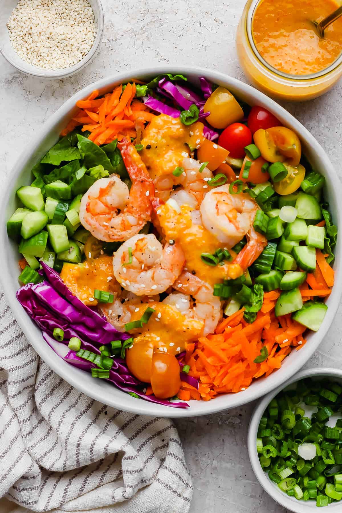 As assembled ginger salad topped with carrot ginger salad dressing.