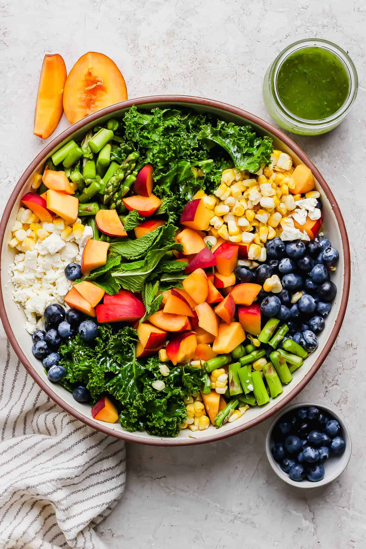 All of the kale salad ingredients in a large bowl.