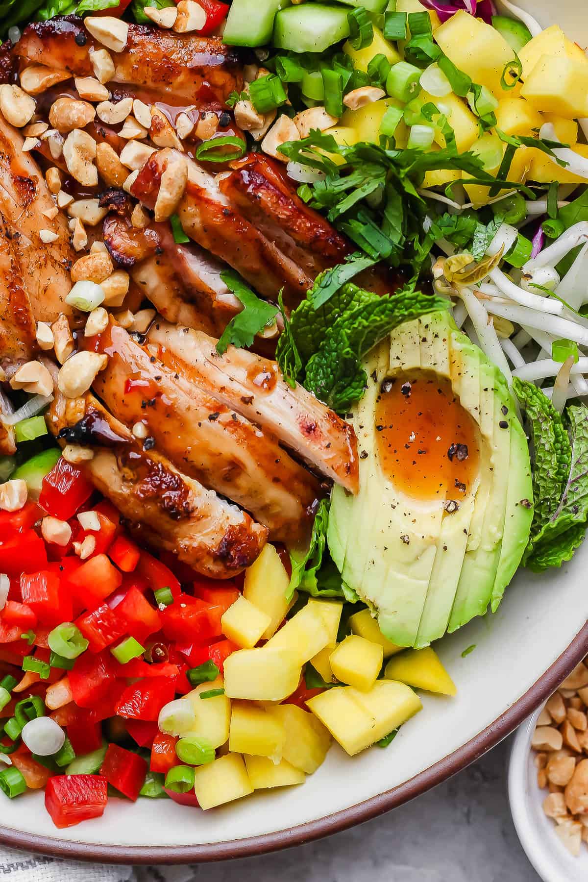 A large serving bowl with the spring roll salad fully assembled.