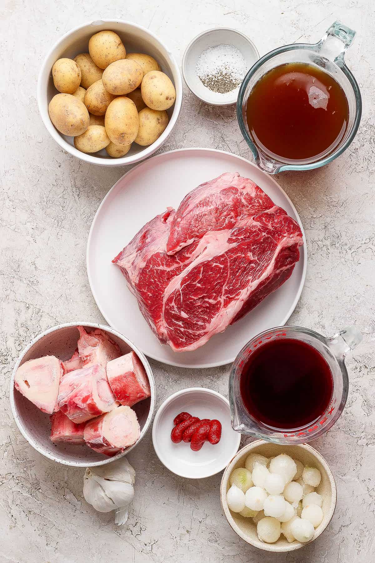 Ingredients for dutch oven pot roast in separate bowls.