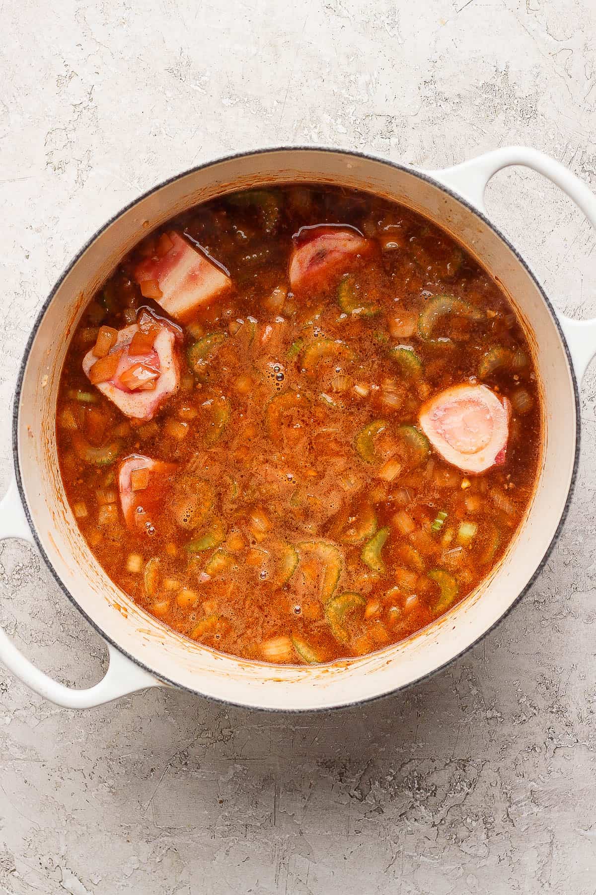 All of the liquid ingredients added to the pot, plus the beef soup bones.