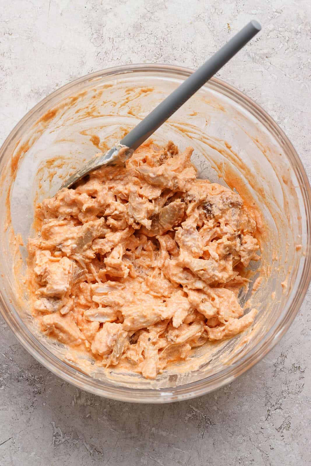 Blended cottage cheese, franks red hot sauce, and shredded chicken all mixed together in a large bowl