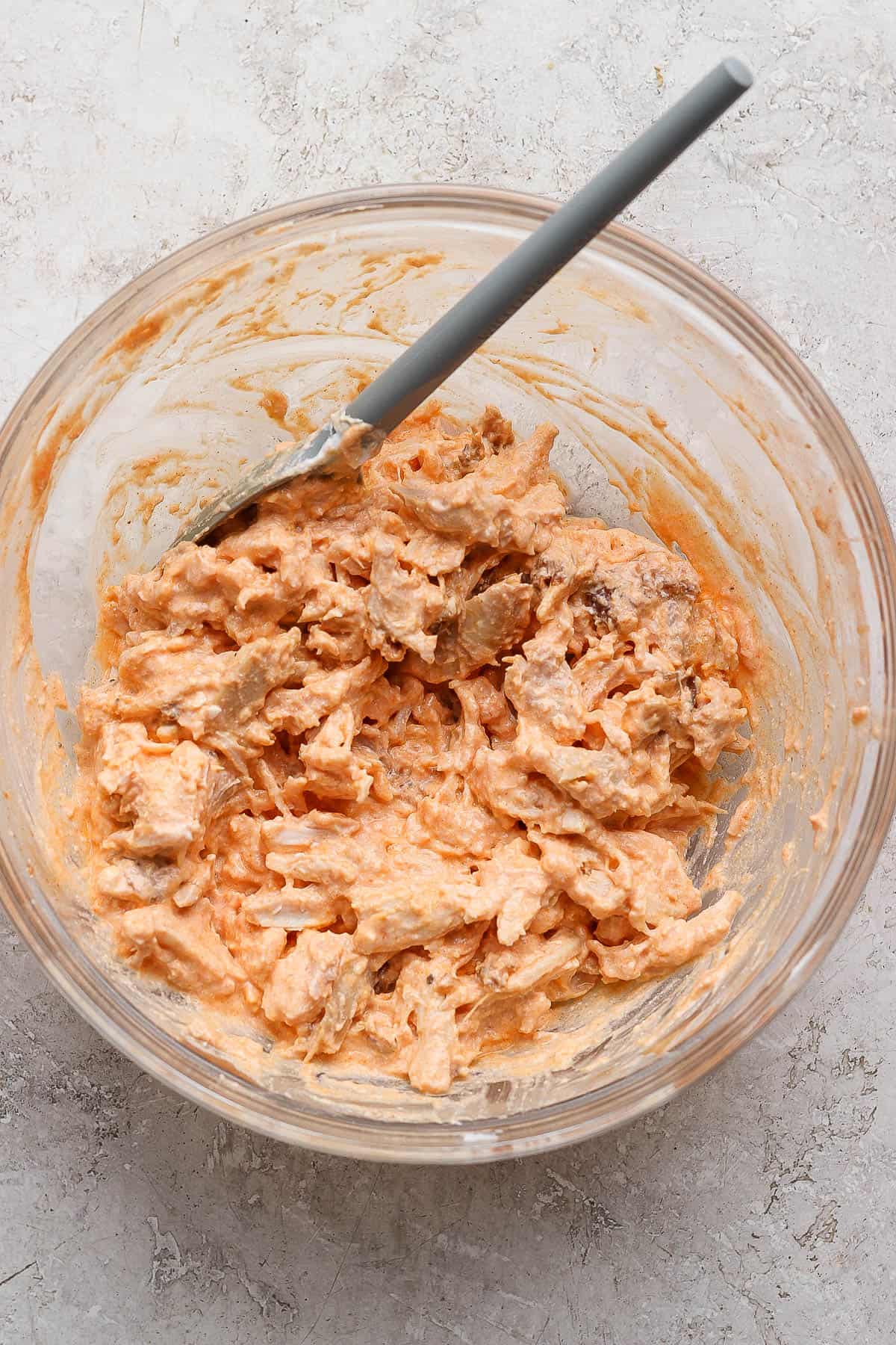 Blended cottage cheese, franks red hot sauce, and shredded chicken all mixed together in a large bowl