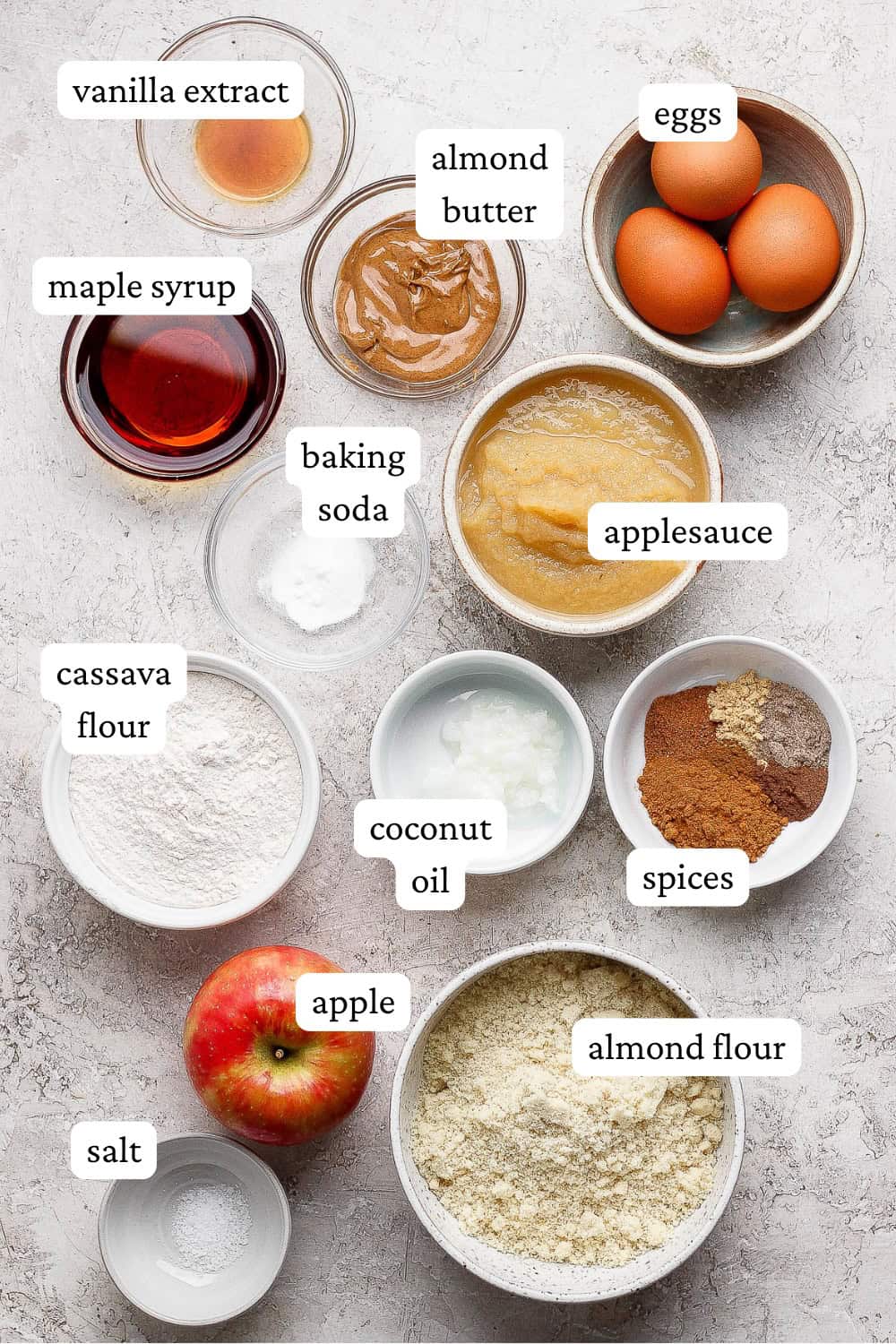 Ingredients for apple cinnamon muffins in separate bowls.