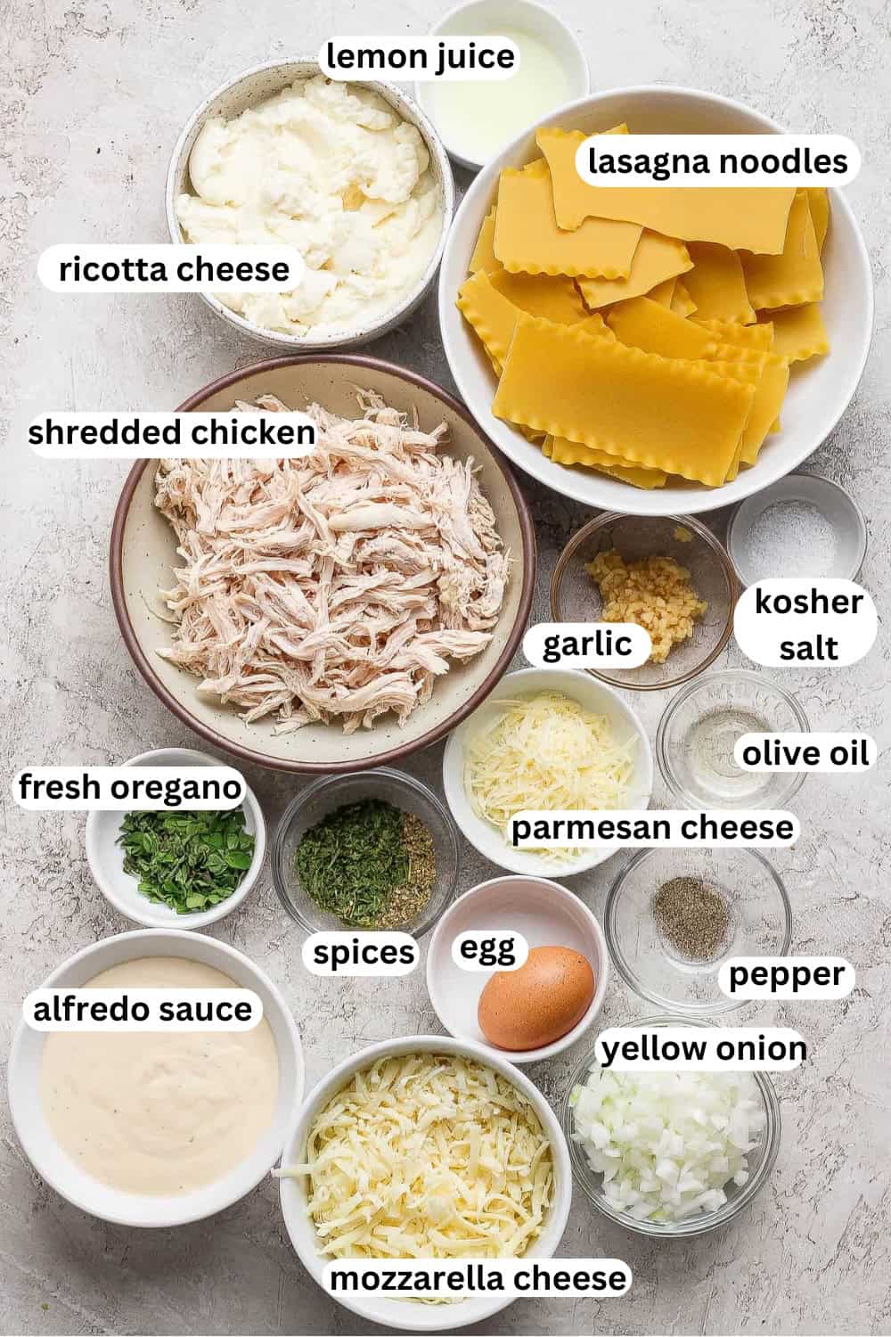 Ingredients for sheet pan lasagna in separate bowls and with labels on them.