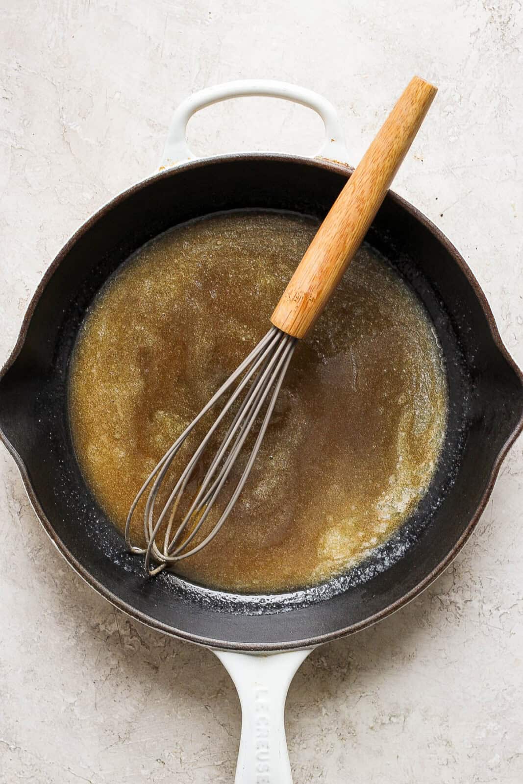 The butter brown sugar mixture whisked together in a cast iron skillet.