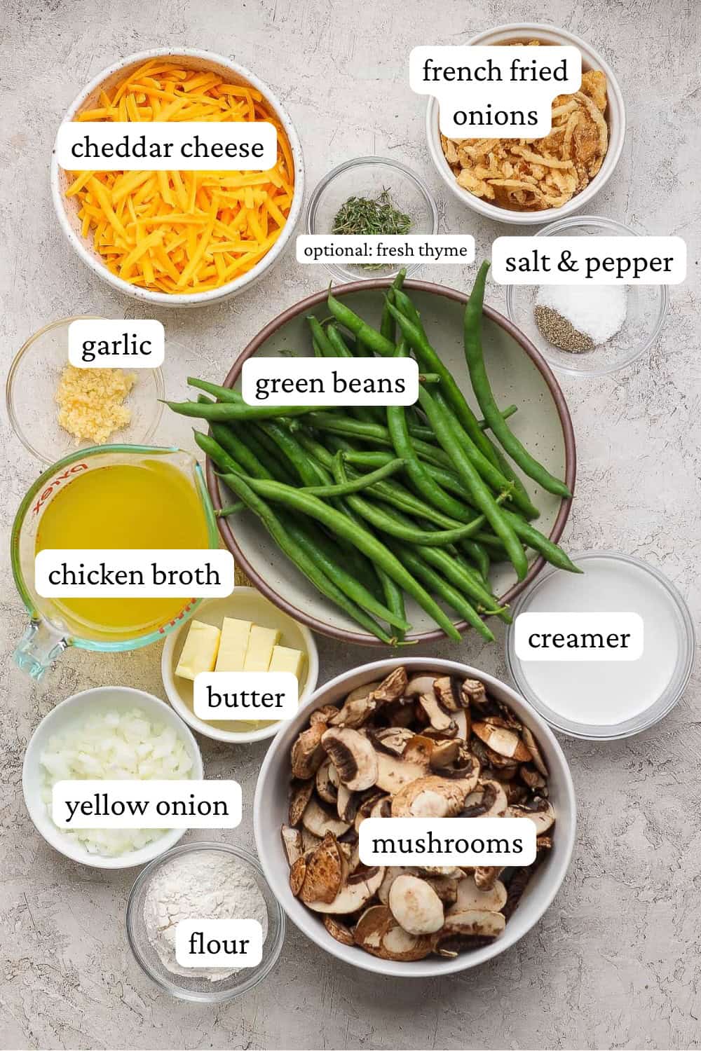 Ingredients for cheesy green bean casserole in separate bowls with labels.