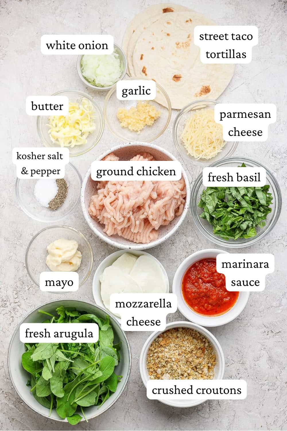 Ingredients for chicken parm smash tacos in separate bowls with labels.