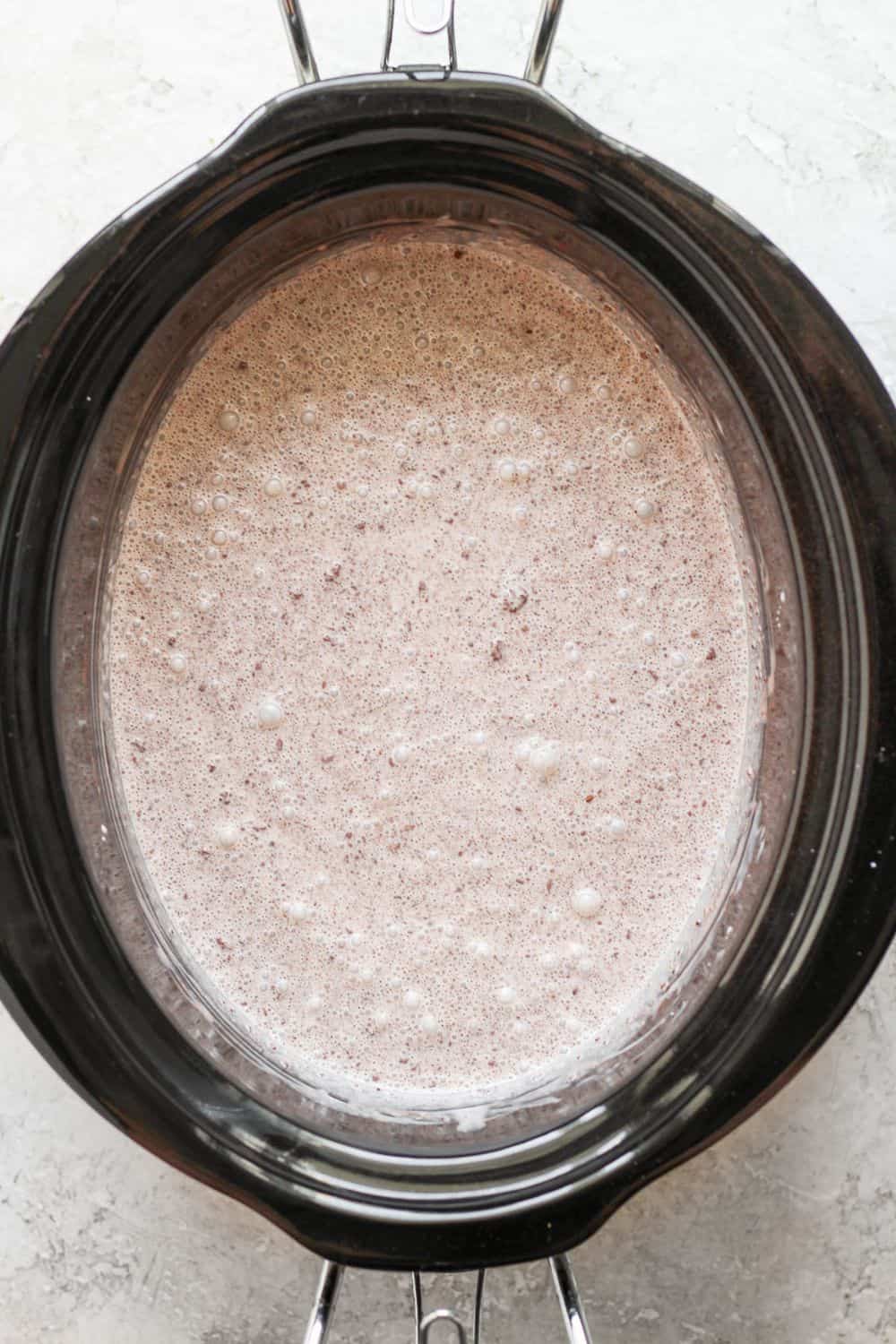 Chocolate chips added to the crock pot mixture and mixed to be combined.