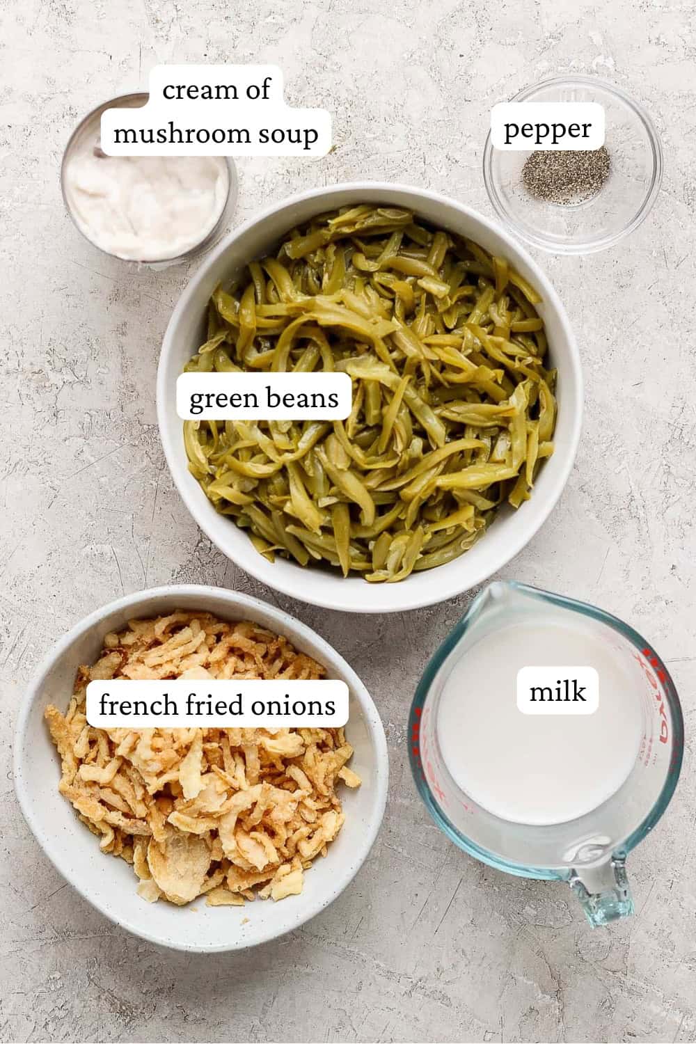 Ingredients for an easy green bean casserole in separate bowls with labels.