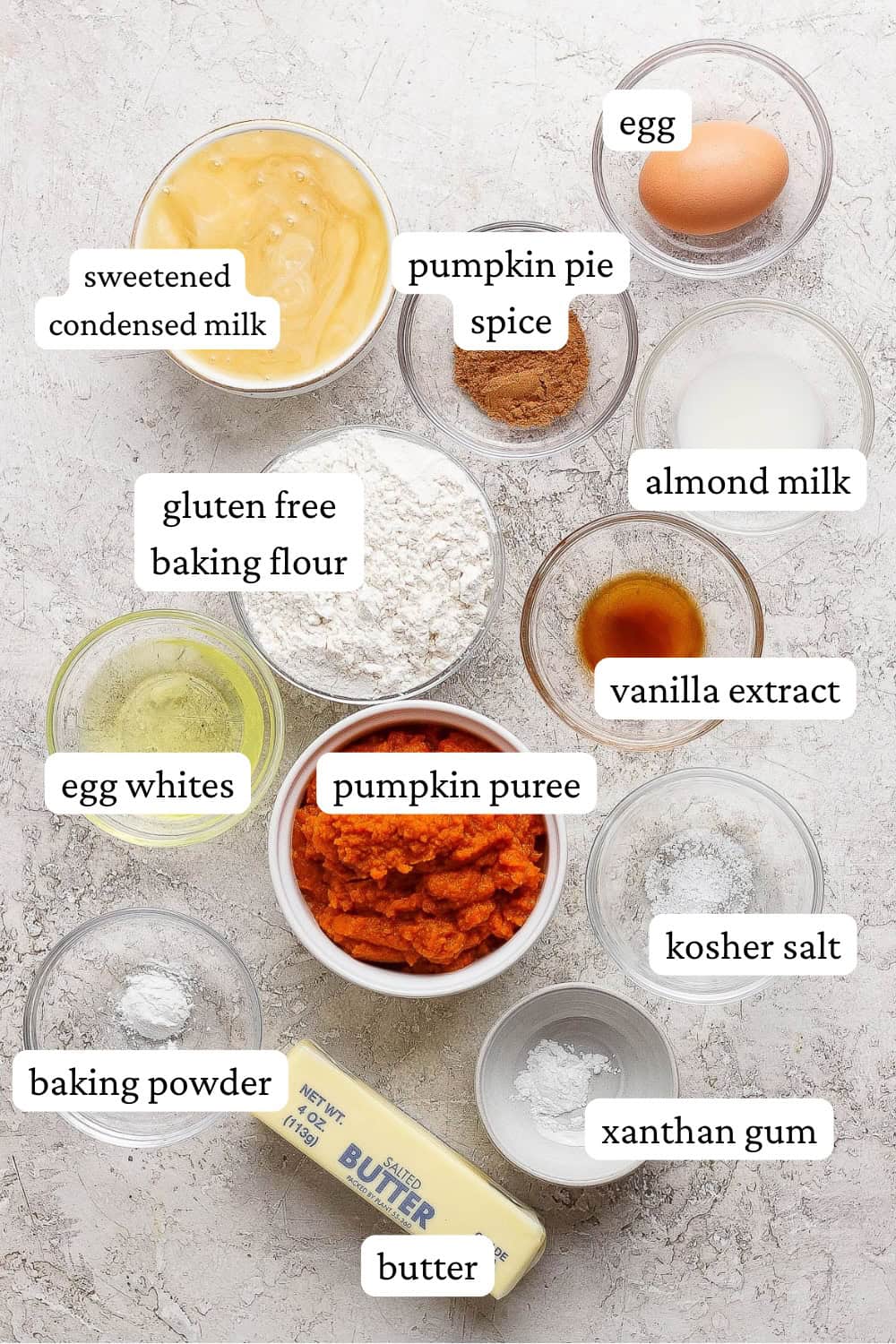 Ingredients for a gluten free pumpkin pie in separate bowls.