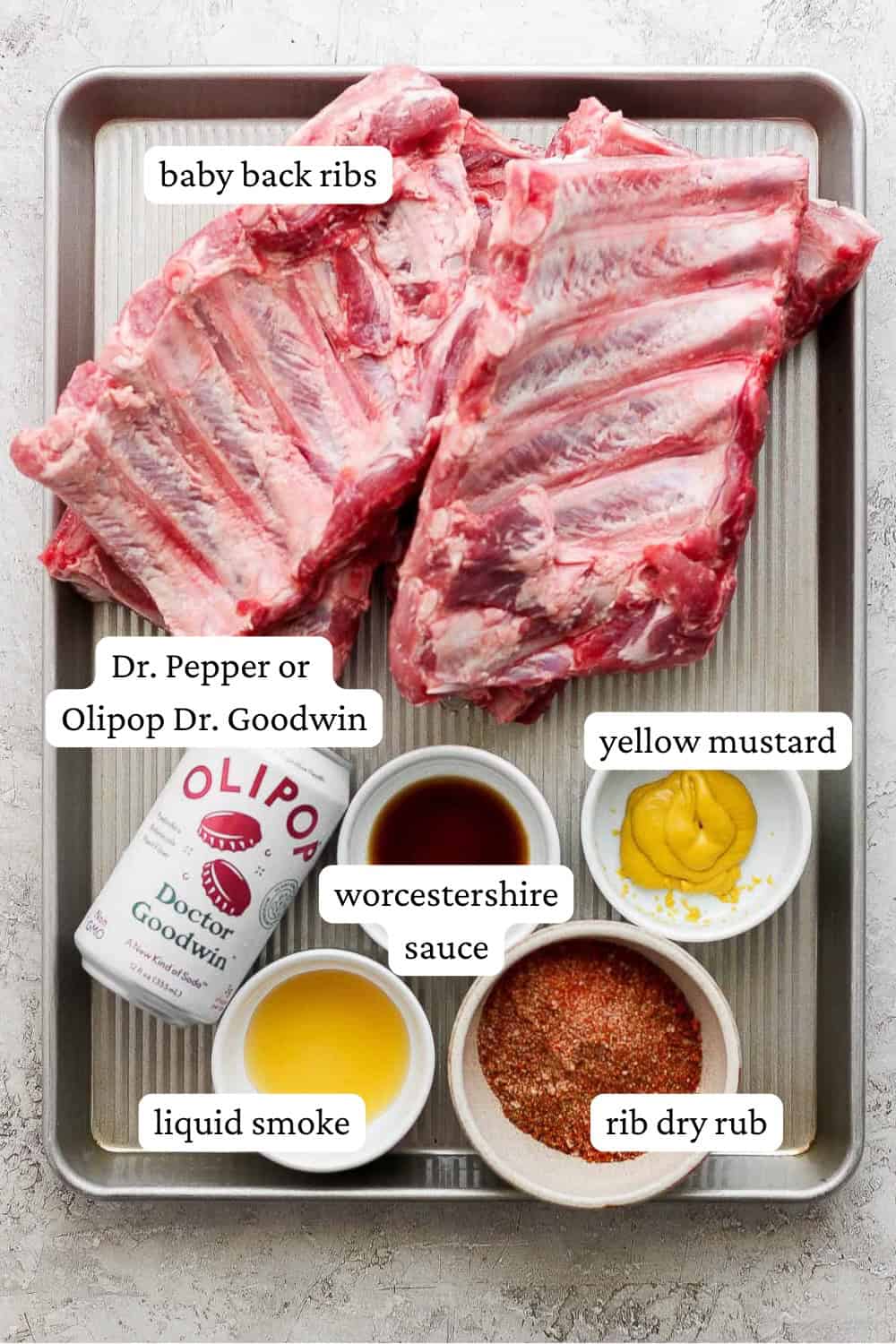 Ingredients for instant pot ribs on a baking sheet in separate bowls.