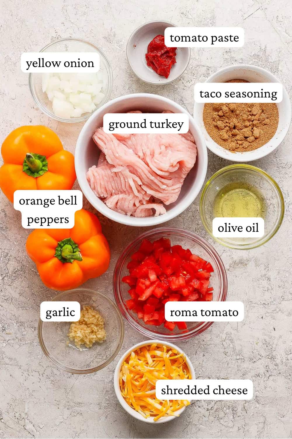Ingredients for jack o lantern stuffed peppers in separate bowls.