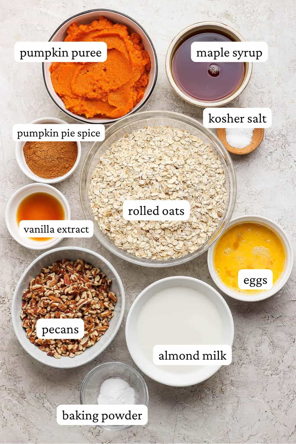 Pumpkin baked oatmeal ingredients in separate bowls with labels.